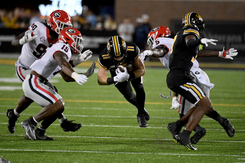 Missouri wide receiver Barrett Banister (11) dives with the ball as Georgia defensive lineman Tramel Walthour (90), linebacker Trezmen Marshall (15) and defensive back Kelee Ringo (5) defend during the first half of an NCAA college football game Saturday, Oct. 1, 2022, in Columbia, Mo. (AP Photo/L.G. Patterson)
