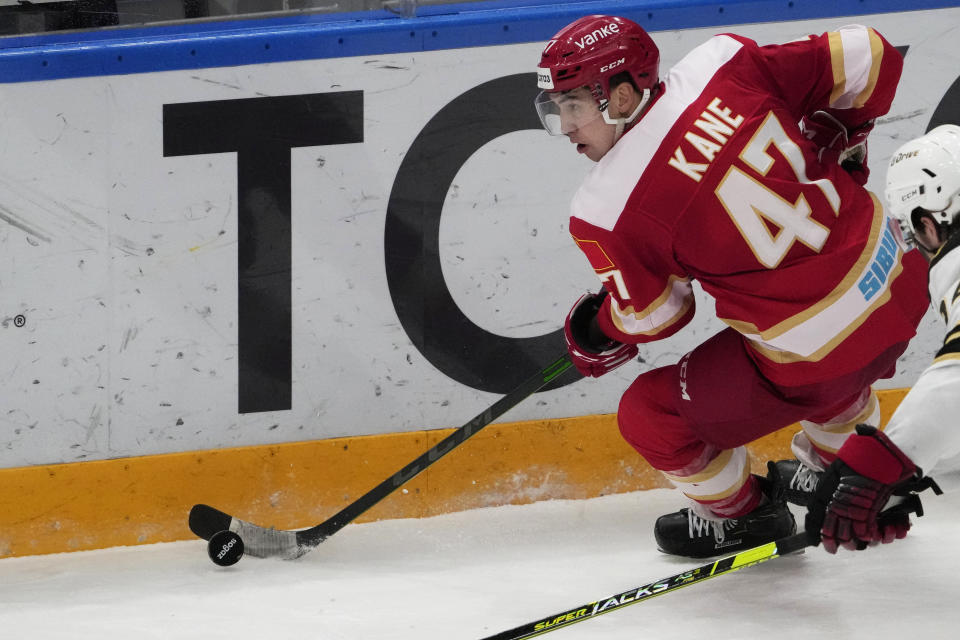 Kunlun Red Star's Cory Kane controls the puck during the Kontinental Hockey League ice hockey match between Kunlun Red Star Beijing and Avangard Omsk in Mytishchi, outside Moscow, Russia, Wednesday, Nov. 17, 2021. (AP Photo/Pavel Golovkin)