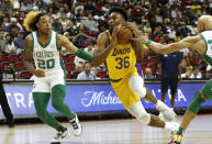 Los Angeles Lakes guard Bryce Hamilton (36) drives between Boston Celtics guard J.D. Davison (20) and forward Jordan Walsh during the first half of an NBA summer league basketball game Wednesday, July 12, 2023, in Las Vegas. (Steve Marcus/Las Vegas Sun via AP)