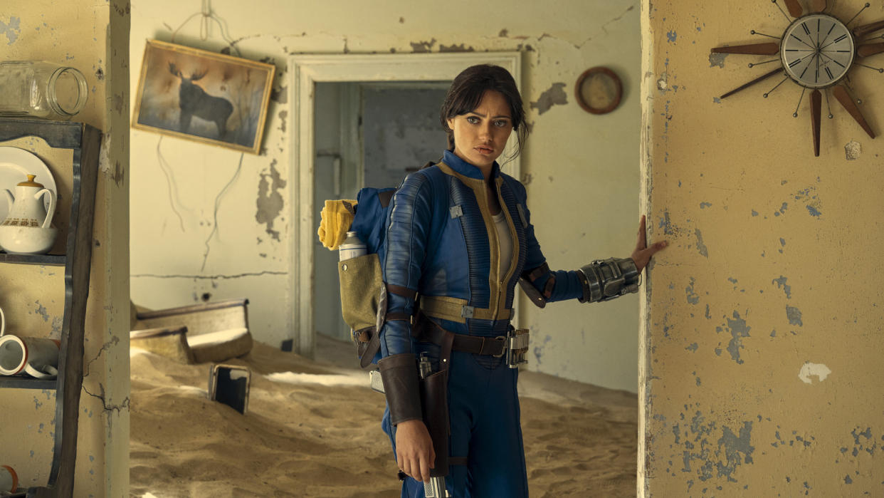  Lucy explores an abandoned, ruined home in Amazon's Fallout TV series. 