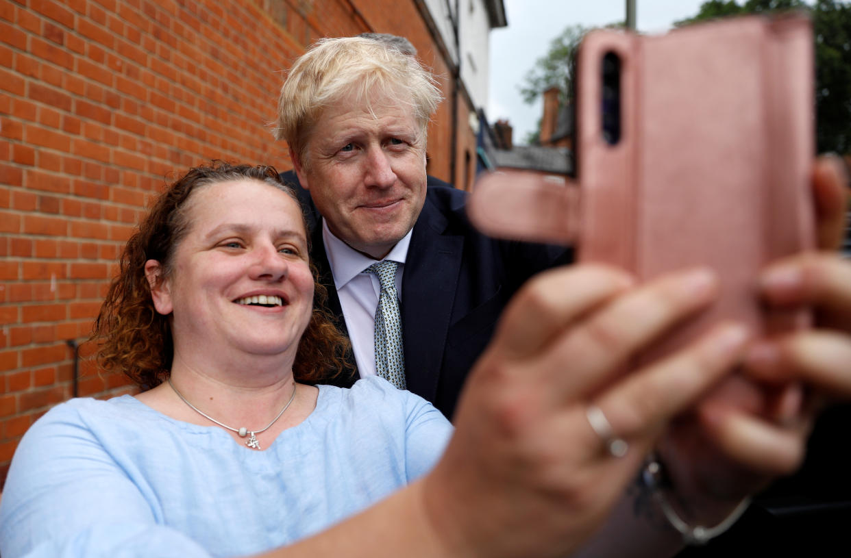 Boris Johnson, a leadership candidate for Britain's Conservative Party, poses for a selfie in Oxshott, Surrey, Britain, June 25, 2019. REUTERS/Peter Nicholls