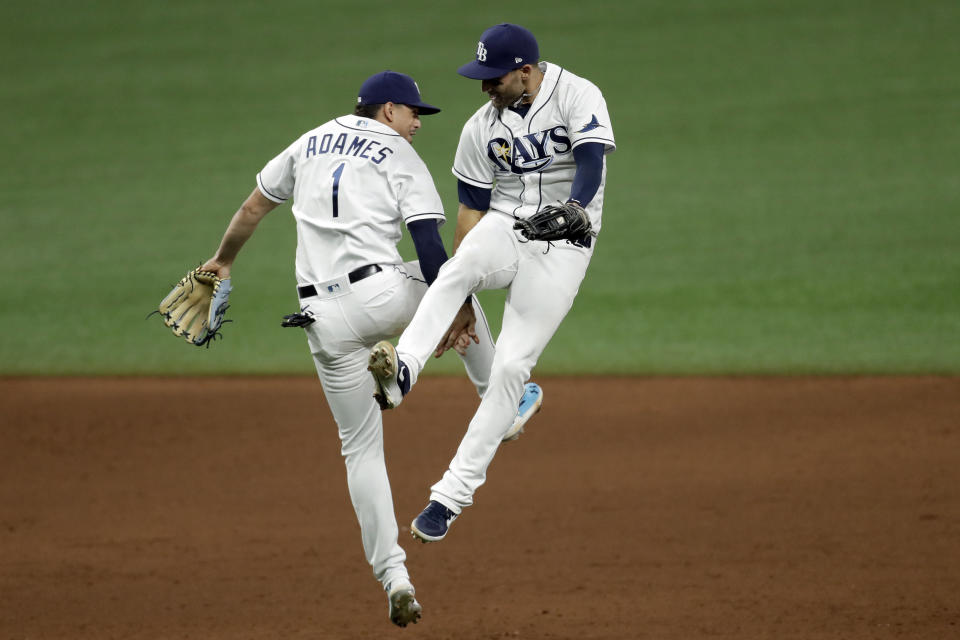 Tampa Bay Rays center fielder Kevin Kiermaier and shortstop Willy Adames (1) celebrate after the team defeated the New York Yankees during a baseball game Friday, Aug. 7, 2020, in St. Petersburg, Fla. (AP Photo/Chris O'Meara)