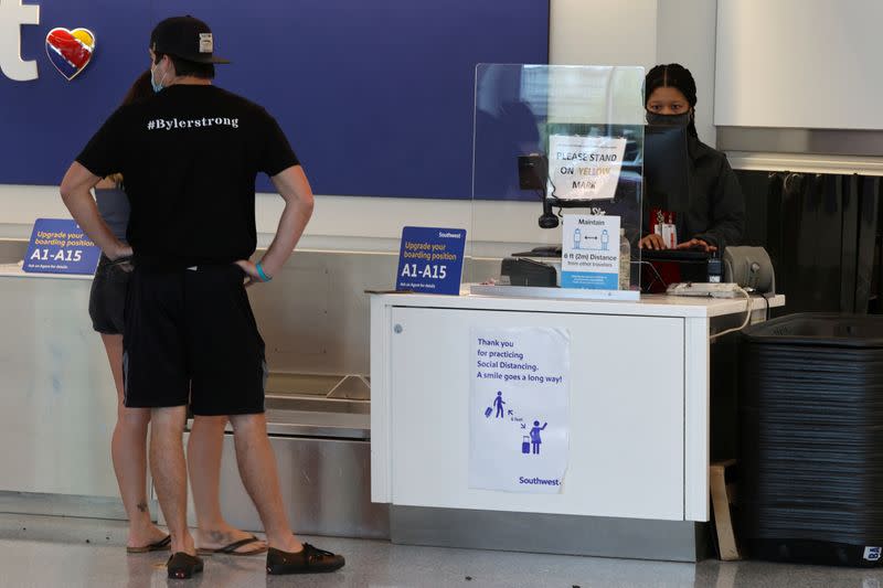 FILE PHOTO: A Southwest Airlines customer service desk is seen with a social distancing advisory at LAX airport, as the global outbreak of the coronavirus disease (COVID-19) continues, in Los Angeles