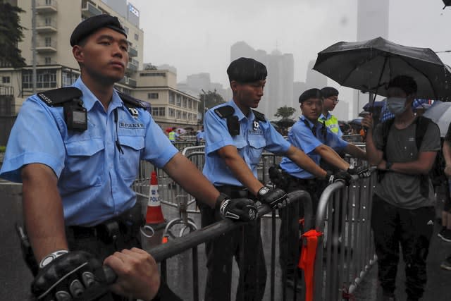 Policemen stand guard in the rain as protesters gather near the Legislative Council in Hong Kong