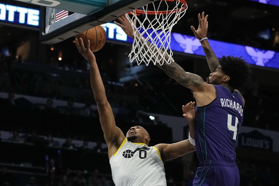 Utah Jazz guard Talen Horton-Tucker scores past Charlotte Hornets center Nick Richards during the first half of an NBA basketball game on Saturday, March 11, 2023, in Charlotte, N.C. (AP Photo/Chris Carlson)