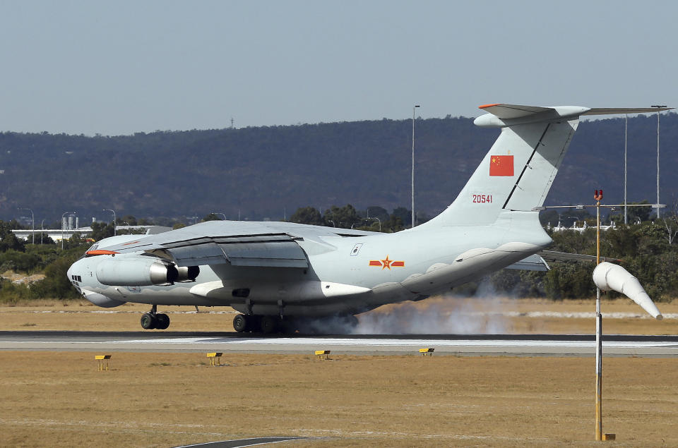 A Chinese Ilyushin IL-76 aircraft comes in for a landing at Perth International Airport after returning from the ongoing search operations for missing Malaysia Airlines Flight 370 in Perth, Australia, Thursday, April 10, 2014. With hopes high that search crews are zeroing in on the missing Malaysian jetliner's crash site, ships and planes hunting for the aircraft intensified their efforts Thursday after equipment picked up sounds consistent with a plane's black box in the deep waters of the Indian Ocean. (AP Photo/Rob Griffith)