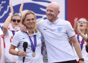 England head coach Sarina Wiegman, left, and Arjan Veurink on stage at an event at Trafalgar Square in London, Monday, Aug. 1, 2022. England beat Germany 2-1 and won the final of the Women's Euro 2022 on Sunday. (James Manning/PA via AP)