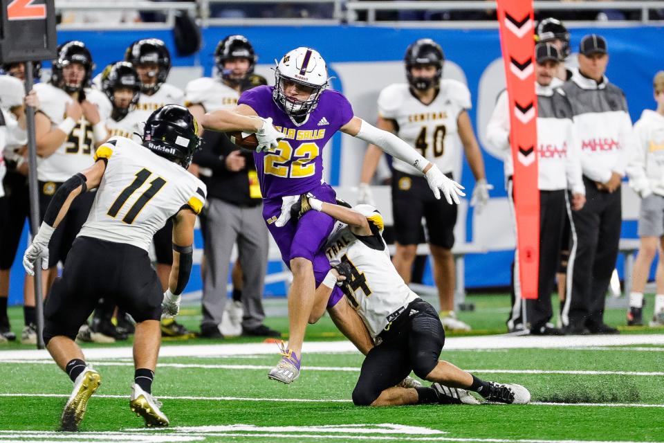 Warren De La Salle wide receiver Jack Yanachik runs against Traverse City Central defensive back Braxton Hill during the first half of the Division 2 state final on Friday, Nov. 26, 2021, at Ford Field.