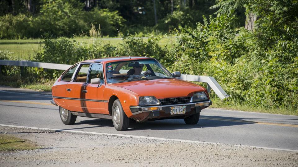 an orange car on a road