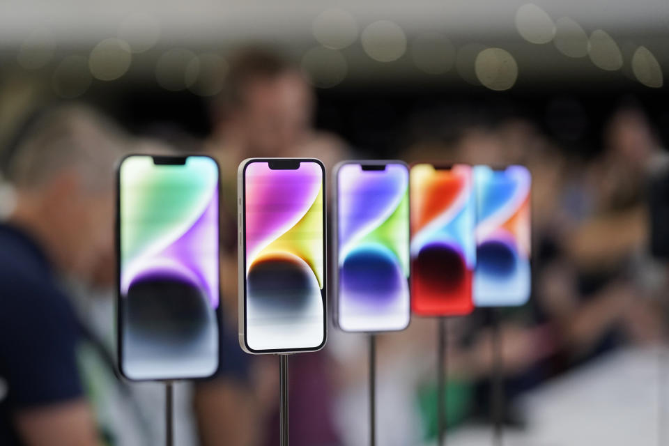 FILE- New iPhone 14 models on display at an Apple event on the campus of Apple's headquarters in Cupertino, Calif., Sept. 7, 2022. Apple Inc. will manufacture its latest iPhone 14 in India, the company said on Monday, as it seeks to curb its production in China. (AP Photo/Jeff Chiu, File)