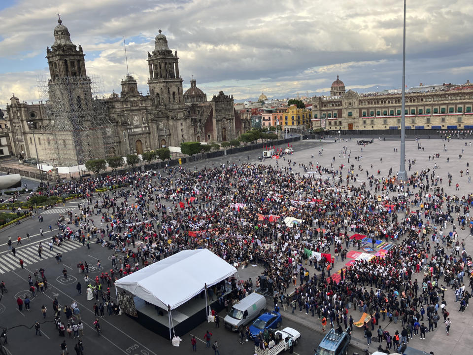 Relatives and classmates of the missing 43 Ayotzinapa college students and their supporters gather in Mexico City's main square the Zocalo, Monday, Sept. 26, 2022, on the day of the anniversary of the disappearance of the students in Iguala, Guerrero state. Three members of the military and a former federal attorney general were recently arrested in the case, and few now believe the government's initial claim that a local drug gang and allied local officials were wholly to blame for seizing and killing the students on July 26, 2014, most of which have never been found. (AP Photo/Marco Ugarte)