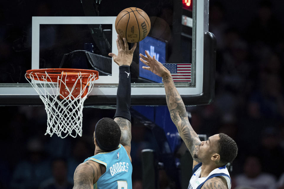 Charlotte Hornets forward Miles Bridges (0) blocks a shot from Dallas Mavericks forward P.J. Washington (25) during the first half of an NBA basketball game Tuesday, April 9, 2024, in Charlotte, N.C. (AP Photo/Jacob Kupferman)