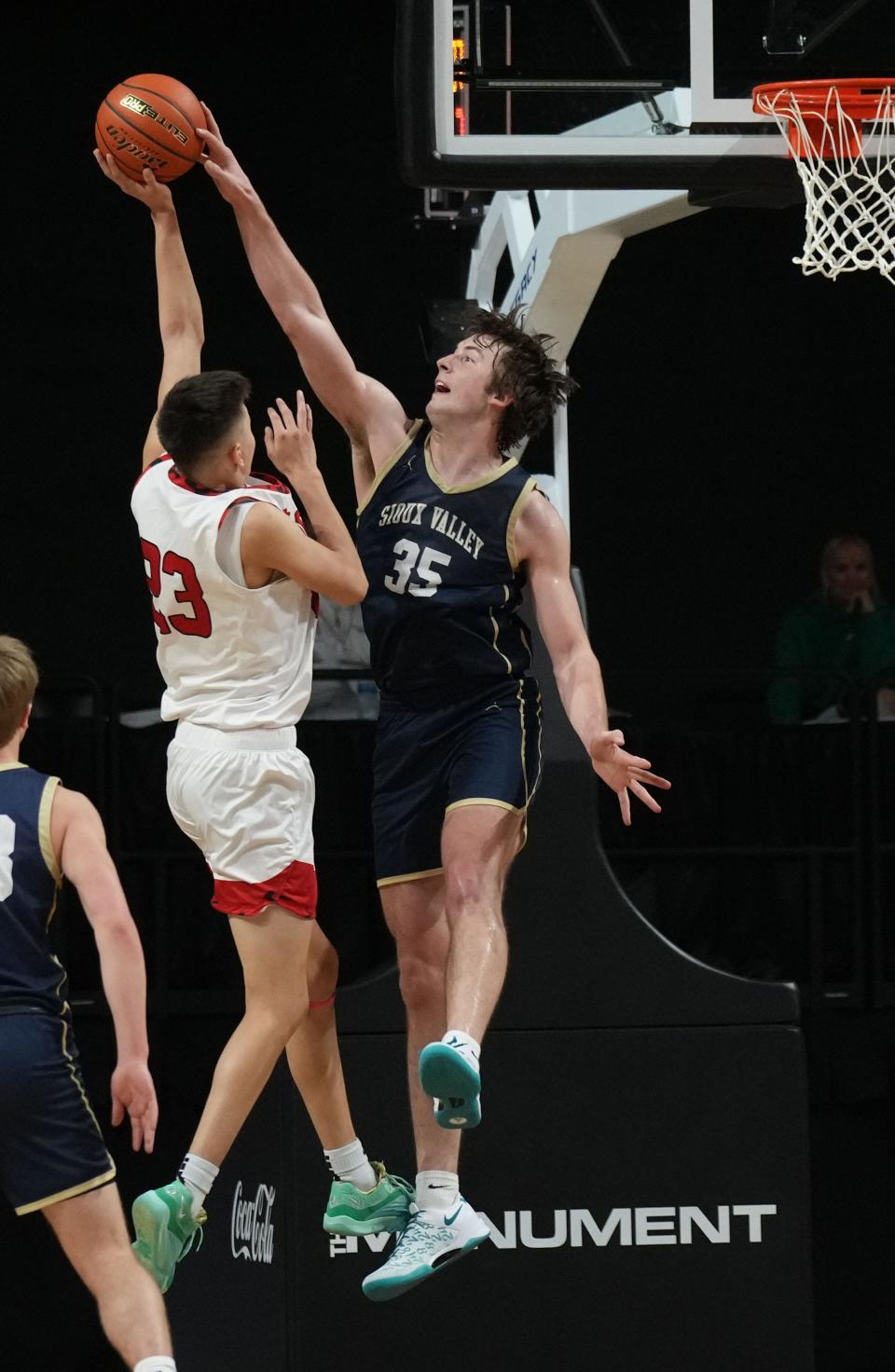 Sioux Valley's Alec Squires blocks a shot by Pine Ridge's Kanye Hollow Horn during the consolation championship game of the state Class A boys basketball tournament on Saturday, March 16, 2024 in the Summit Arena at The Monument in Rapid City. Sioux Valley won 69-51.
