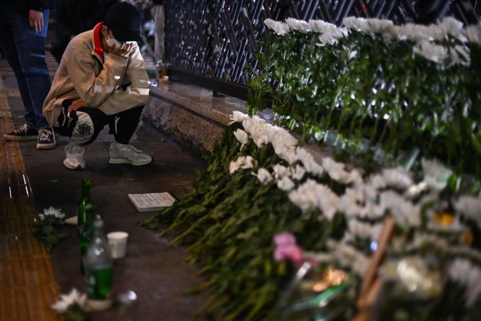 <div class="inline-image__title">1244345677</div> <div class="inline-image__caption"><p>A man reacts as he squats next to a makeshift memorial outside the Itaewon subway station in the district of Itaewon in Seoul on October 30, 2022, the day after a Halloween stampede in the area.</p></div> <div class="inline-image__credit">ANTHONY WALLACE/AFP via Getty Images</div>
