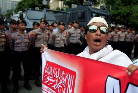 A hard-line Muslim group member shouts slogans during a protest against former Jakarta Governor Basuki Tjahaja Purnama in front of North Jakarta District Court in Jakarta, Indonesia February 26, 2018. REUTERS/Beawiharta