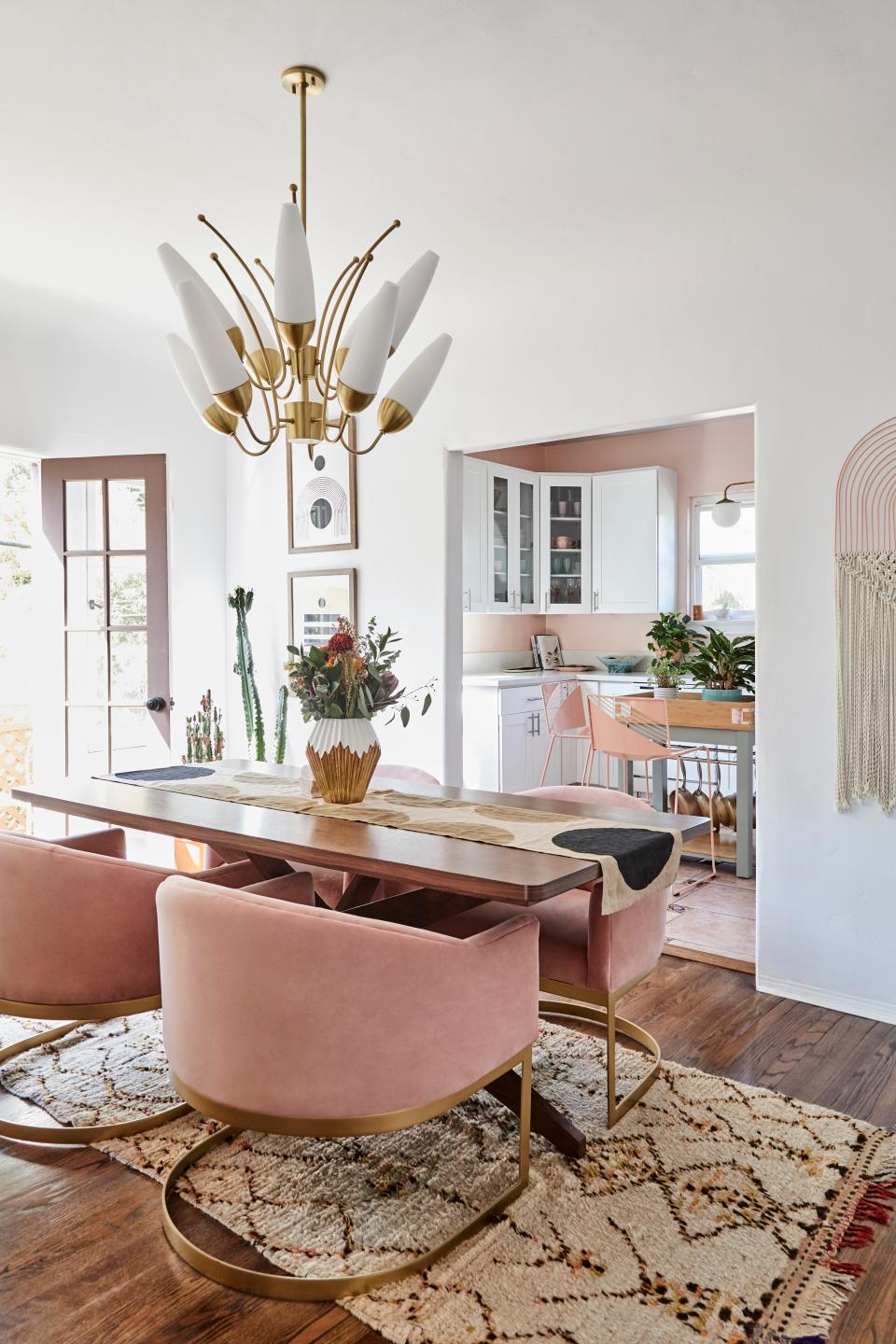 Brightening the space beyond the natural light is the bouquet-like brass chandelier. The dining table, chairs, and credenza (not pictured) are from Joybird.