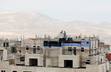 Labourers work on the construction of a building in the West Bank Jewish settlement of Maale Adumim May 24, 2016. REUTERS/Baz Ratner