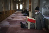 People pray at the Eyup Sultan Mosque, in Istanbul, Monday, April 12, 2021, a day before Ramadan. Turkey's President Recep Tayyip Erdogan was forced to announce renewed restrictions following a spike on COVID-19 cases, such as weekend lockdowns and the closure of cafes and restaurants during Ramadan, the holy Muslim month, starting on April 13. (AP Photo/Emrah Gurel)