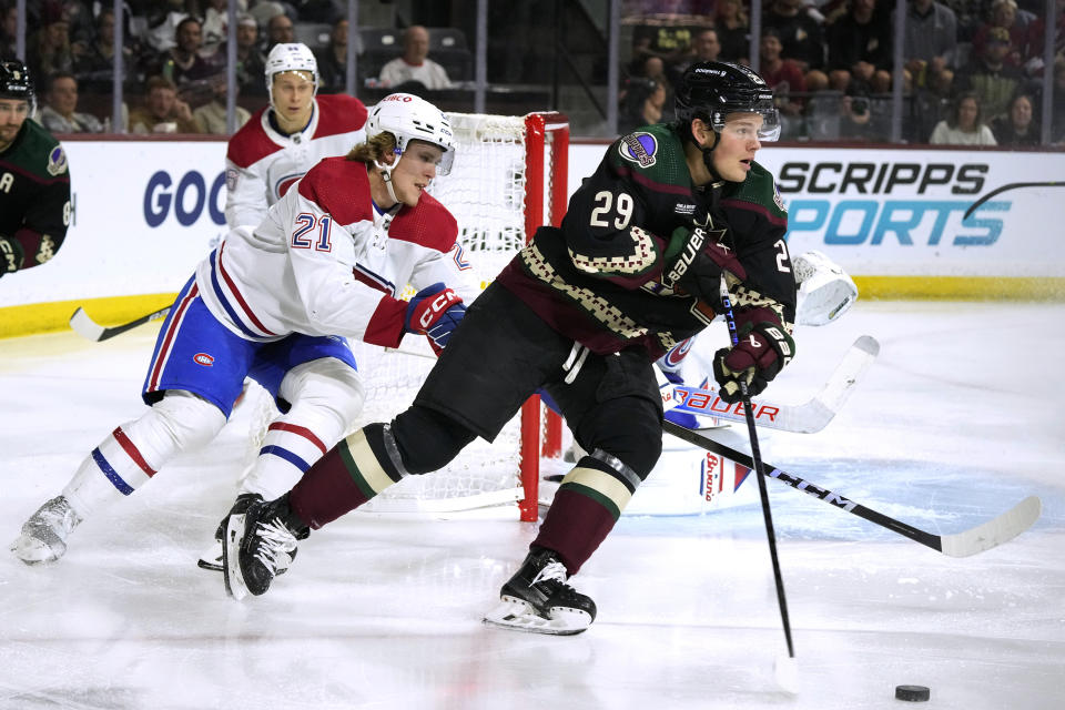 Arizona Coyotes center Barrett Hayton (29) skates with the puck next to Montreal Canadiens defenseman Kaiden Guhle (21) during the third period of an NHL hockey game Thursday, Nov. 2, 2023, in Tempe, Ariz. (AP Photo/Ross D. Franklin)