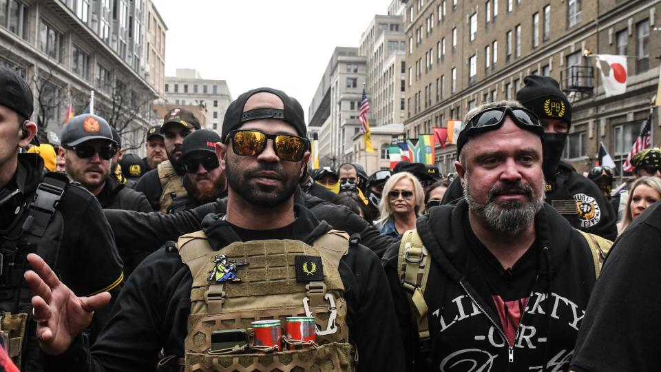 Enrique Tarrio, leader of the Proud Boys (L) and Joe Biggs (R) gather outside of Harry's bar during a protest on December 12, 2020 in Washington, DC. (Photo by Stephanie Keith/Getty Images)