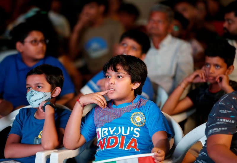 FILE PHOTO: Young Indian cricket fans react as they watch live broadcasting of the first match between India and Pakistan in Twenty20 World Cup, in Ahmedabad