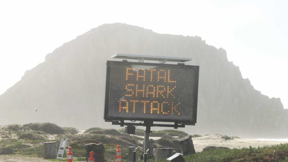 A sign posted on the beach in Morro Bay on Christmas Eve, Dec. 24, 2021, warns of a fatal shark attack in the area known as The Pit.