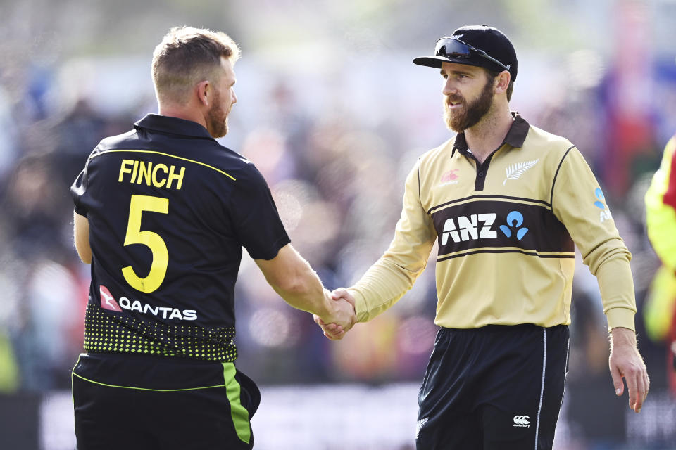 Australian captain Aaron Finch, left, shakes hands with New Zealand captain Kane Williamson after their second T20 cricket international between Australia and New Zealand at University Oval In Dunedin, New Zealand, Thursday, Feb. 25, 2021. (Andrew Cornaga/Photosport via AP)