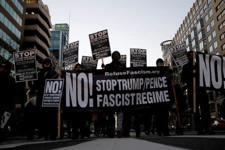 Anti-Trump demonstrators organized by RefuseFascism.org march through the streets of Washington January 18, 2017. REUTERS/James Lawler Duggan