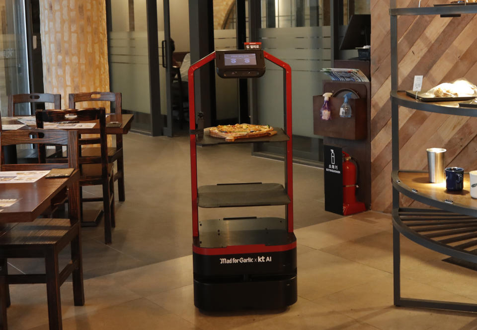 AI serving robot from KT carries a food, during a demonstration at a restaurant in Seoul, South Korea, Tuesday, Sept. 15, 2020. (AP Photo/Lee Jin-man)