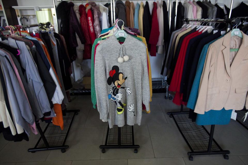 In this Dec. 9, 2011 photo, a Minnie Mouse sweater and other clothing items are displayed for sale at a shop in Pyongyang, North Korea. A new culture of commerce is springing up, with China as its inspiration and source. The new consumerism is part of a campaign launched three years ago to build up the economy, and so the image of new leader Kim Jong Un. (AP Photo/David Guttenfelder)