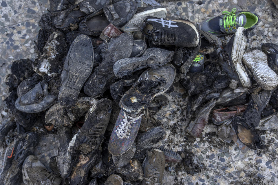 Burnt shoes from an explosion in a sports club are on the ground, in the west of Kabul, Afghanistan, Friday, Oct. 27, 2023. The blast killed some people and injured others in a Shiite neighbourhood in the Afghan capital Kabul. (AP Photo/Ebrahim Noroozi)