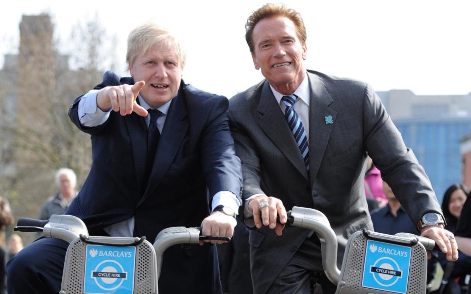 Boris Johnson takes Arnold Schwarzenegger for a ride on one of his 'Boris bikes' during his visit to City Hall in London in 2011 - Stefan Rousseau/PA Wire