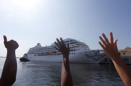 People react during the arrival of U.S. Carnival cruise ship Adonia at the Havana bay, the first cruise liner to sail between the United States and Cuba since Cuba's 1959 revolution, Cuba, May 2, 2016. REUTERS/Stringer