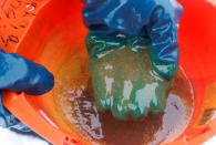 An employee demonstrates a sample of crude oil in the Yarakta Oil Field, owned by Irkutsk Oil Company (INK), in Irkutsk Region, Russia in this picture illustration taken March 10, 2019. REUTERS/Vasily Fedosenko/Illustration