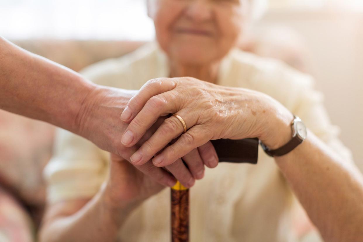 close-up of hands on cane