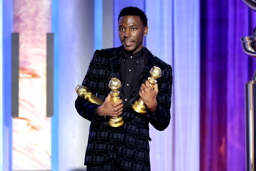 This image released by NBC shows host Jerrod Carmichael holding three Golden Globes during the 80th Annual Golden Globe Awards at the Beverly Hilton Hotel on Tuesday, Jan. 10, 2023, in Beverly Hills, Calif. (Rich Polk/NBC via AP)