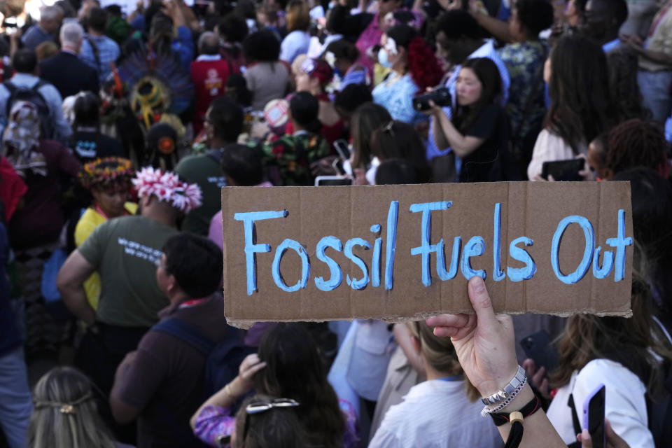 FILE - A sign reading "fossil fuels out" is displayed during a demonstration at the COP27 U.N. Climate Summit, Saturday, Nov. 12, 2022, in Sharm el-Sheikh, Egypt. Simon Stiell, U.N. climate chief, acknowledges nations didn’t do anything additional to address climate change itself at the COP27 U.N. Climate Summit, reducing emissions of heat-trapping gases. The progress made last year at the meeting in Glasgow was maintained, he said. “There was no backtracking." (AP Photo/Peter Dejong, File)