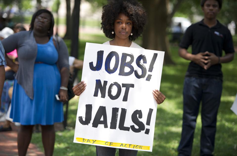 A demonstrator holds a sign during a rally on June 17, 2013. Saul LOEB/AFP/Getty Images