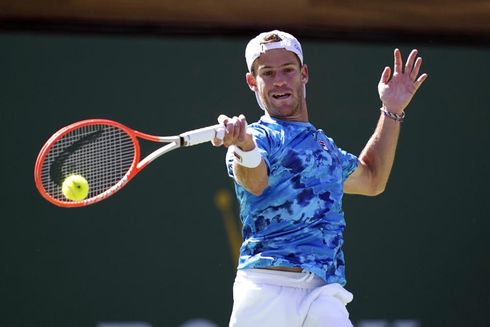 Diego Schwartzman, of Argentina, returns a shot to Cameron Norrie, of Britain, at the BNP Paribas Open tennis tournament Thursday, Oct. 14, 2021, in Indian Wells, Calif. (AP Photo/Mark J. Terrill)