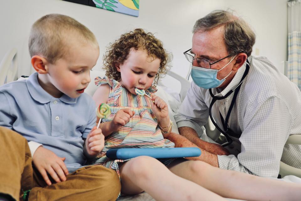 Dr. Robert Frenck, director of the Center for Vaccine Research at Cincinnati Children's Hospital Medical Center joins William, 3, and Lillian, 4, after the children get their injections for a blinded, placebo-controlled clinical trial for the Pfizer COVID-19 vaccine in June. The trial was among several that the center headed for various ages and COVID-19 vaccines.