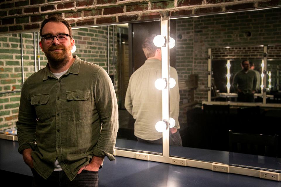 Brian Johannesen poses backstage at the Englert Theatre in Iowa City. The longtime resident is now responsible for booking the acts that come through the downtown venue.