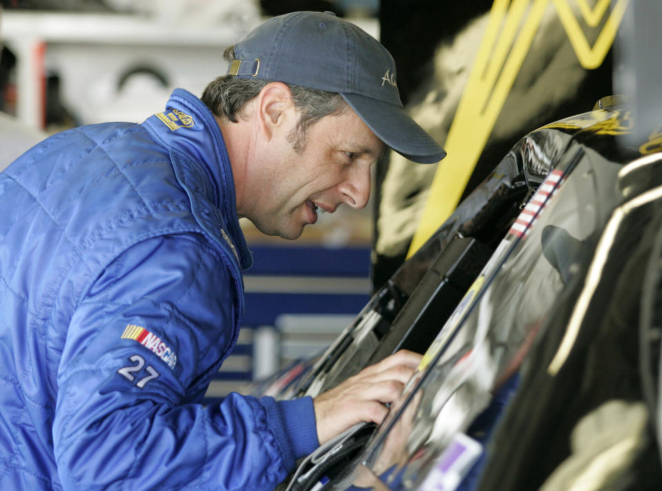 Driver Kirk Shelmerdine checks his car in the garage at Daytona International Speedway in Daytona Beach, Fla., on Feb. 17, 2006. Shelmerdine, a four-time Cup winning crew chief for Dale Earnhardt, was elected to NASCAR's Hall of Fame on Wednesday, May 4 2022. (AP Photo/Terry Renna, File)