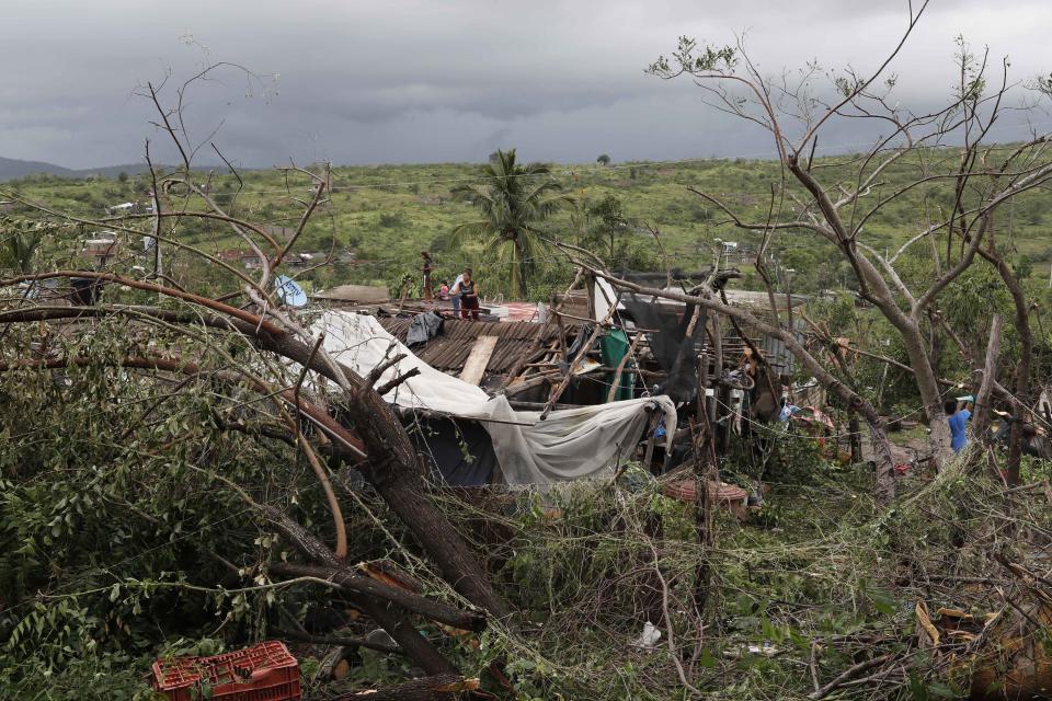 Residents work to put their damaged homes back in order in the aftermath of Hurricane Willa, in Escuinapa, Mexico, Wednesday, Oct. 24, 2018. Emergency workers on Wednesday were struggling to reach beach towns left incommunicado by a blow from Willa. (AP Photo/Marco Ugarte)