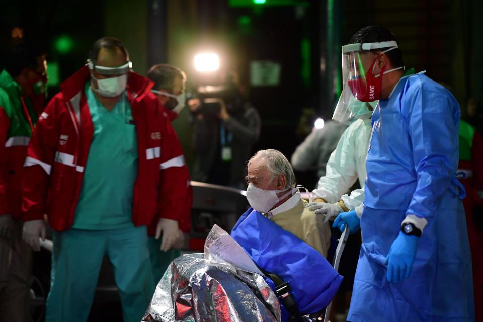 An elderly man with symptoms of Covid-19 is transferred from the Carpe Diem nursing home to a hospital in Buenos Aires: AFP via Getty Images