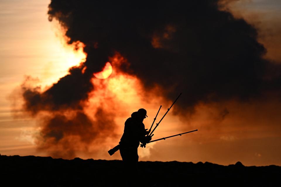 A man adjusts his photographic equipment near Keflavik (AFP via Getty Images)