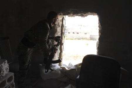 A Free Syrian Army fighter inspects an exit in the al-Khalidiya neighbourhood of Aleppo, September 21, 2013. REUTERS/Aref Hretani