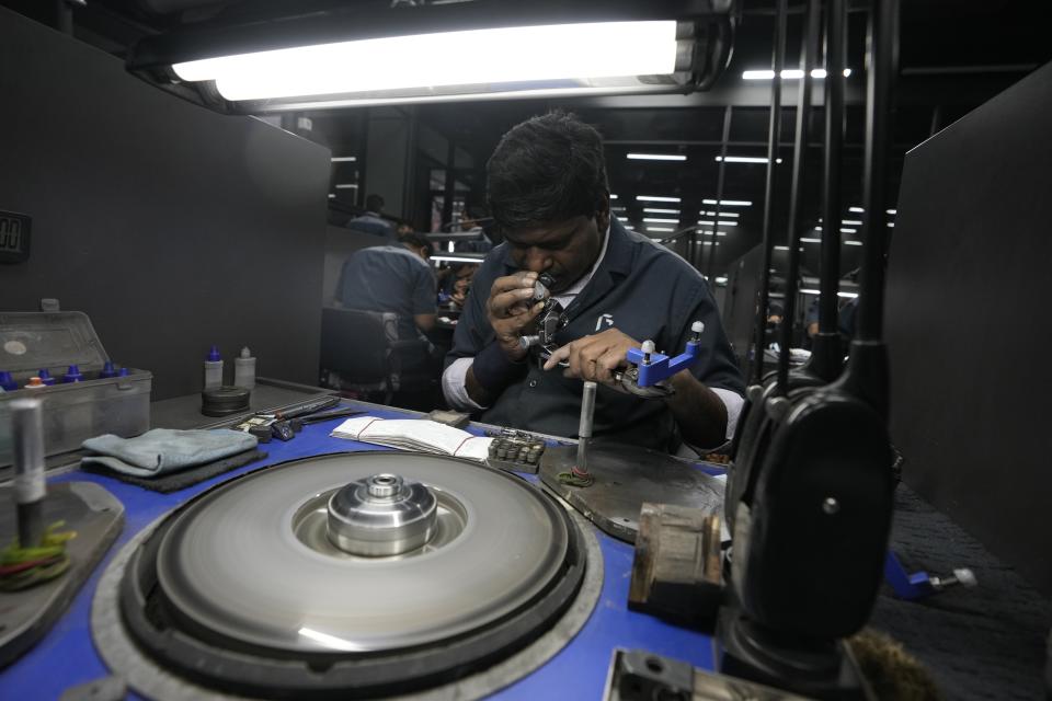 Kurjibhai Makwana checks the polishing of a lab-grown diamond at Greenlab Diamonds, in Surat, India, Monday, Feb. 5, 2024. (AP Photo/Ajit Solanki)