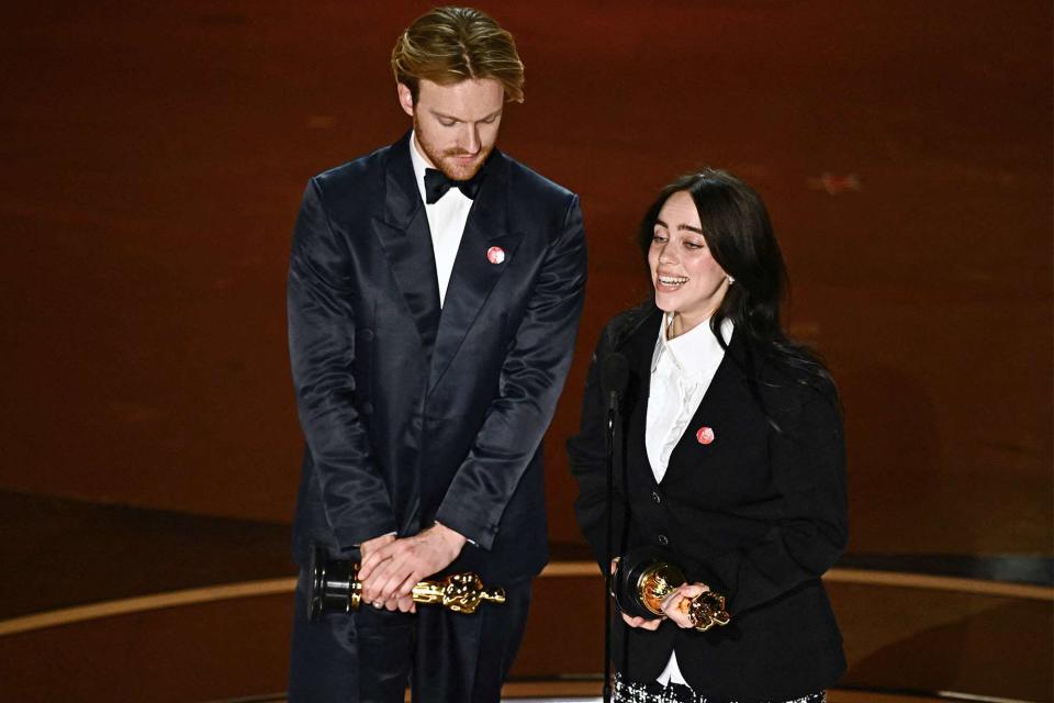 <p>PATRICK T. FALLON/AFP via Getty Images</p> Billie Eilish and Finneas after winning Best Original Song at the Oscars 2024
