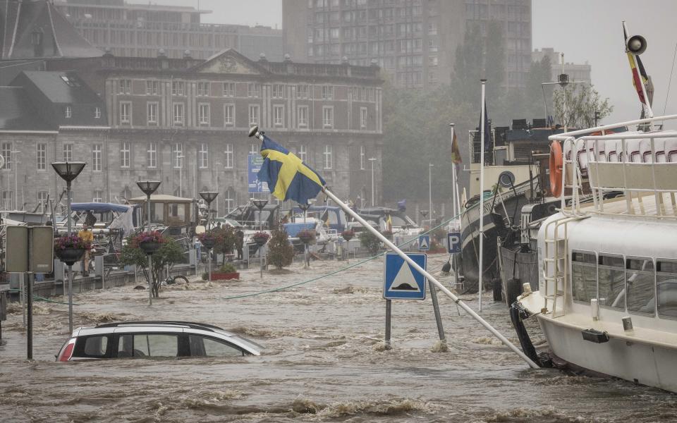 A car floats in the Meuse River during heavy flooding in Liege, Belgium, Thursday, July 15, 2021. Heavy rainfall is causing flooding in several provinces in Belgium with rain expected to last until Friday. (AP Photo/Valentin Bianchi)