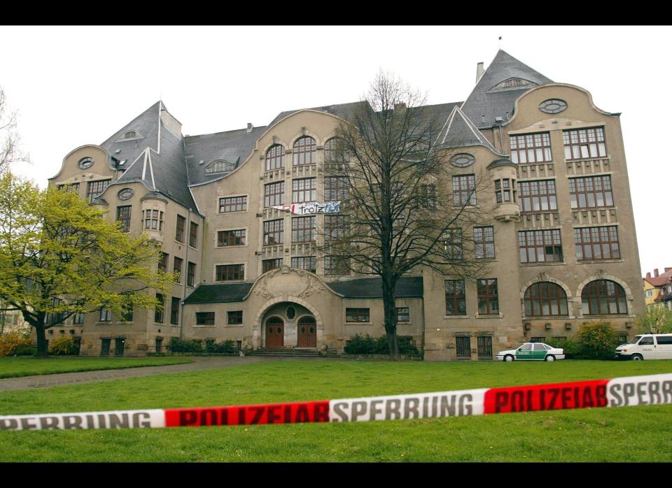 In Erfurt, eastern Germany, 19-year-old Robert Steinhauser opens fire after saying he was not going to take a math test. He kills 12 teachers, a secretary, two pupils and a policeman at the Gutenberg Gymnasium, before killing himself. <br>  <em>Caption: A police tape seals off the area surrounding the Gutenberg high school in Erfurt, eastern Germany, on Friday, April 26, 2002, where a former student of the school shot at least 18 people and injuring many others, before killing himself. (AP Photo/Eckehard Schulz)</em>